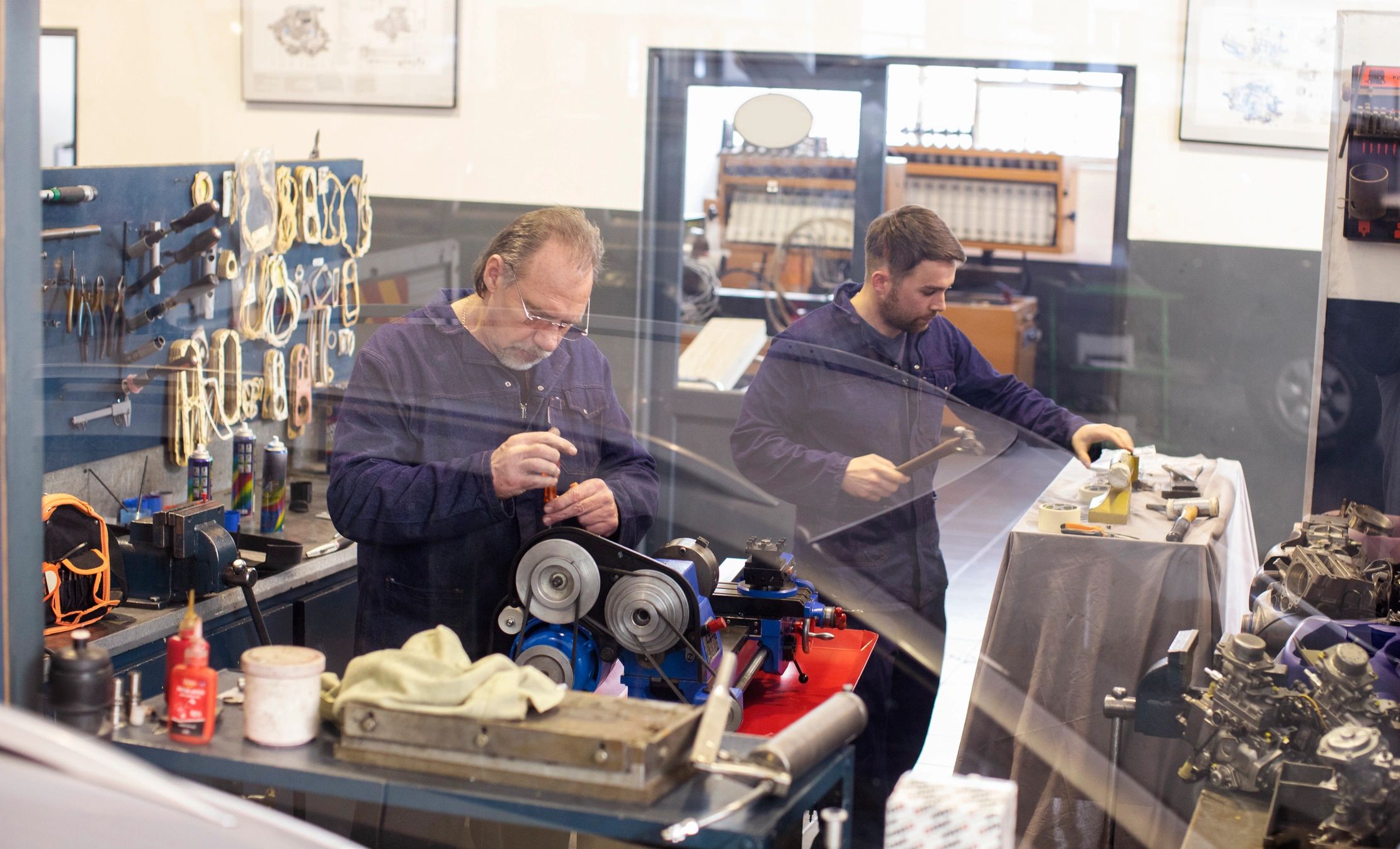 Two people working together in a workshop, representing craftsmanship and mentorship