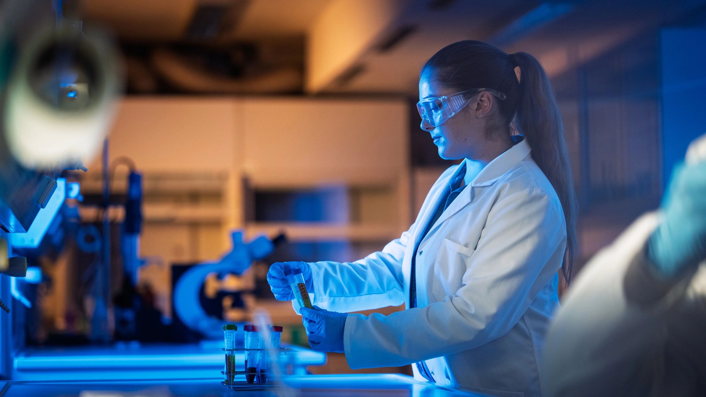 Scientist handling vials with precision in a laboratory